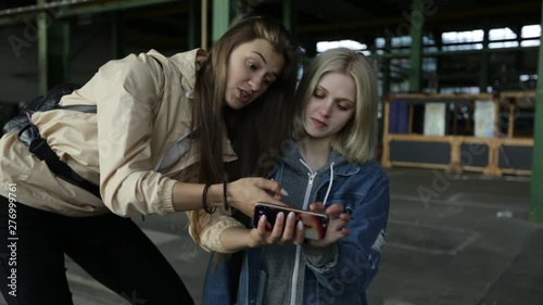 Two girls stand in a hangar