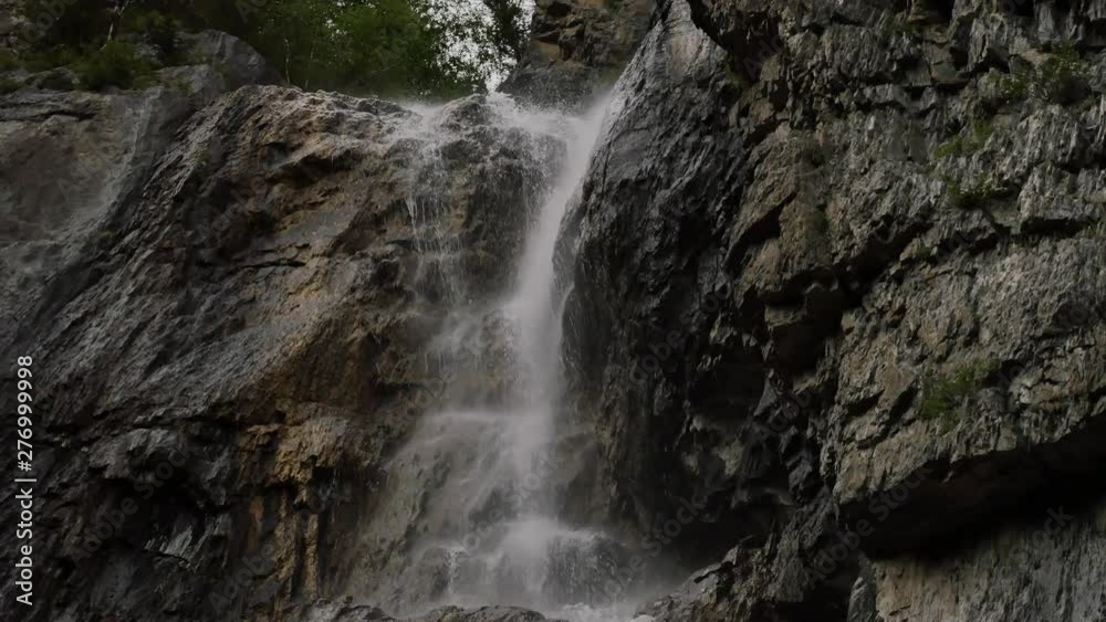 small waterfall from a mountain river in low mountains. powerful stream flows over the stones. 4K small waterfall from a mountain river in low mountains. powerful stream flows over the stones. 4K
