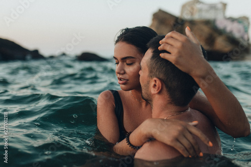 lovely couple kissing in the sea