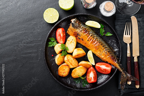 Grilled mackerel fish with roasted potatoes and vegetables.