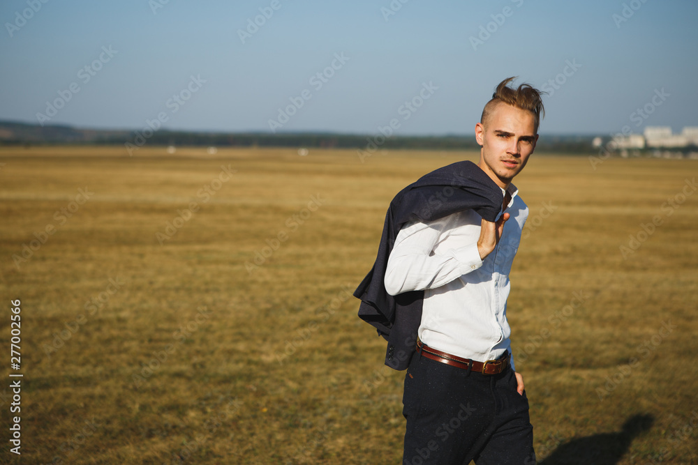 A guy in a suit walks on the field. A guy in a suit walks on the field.