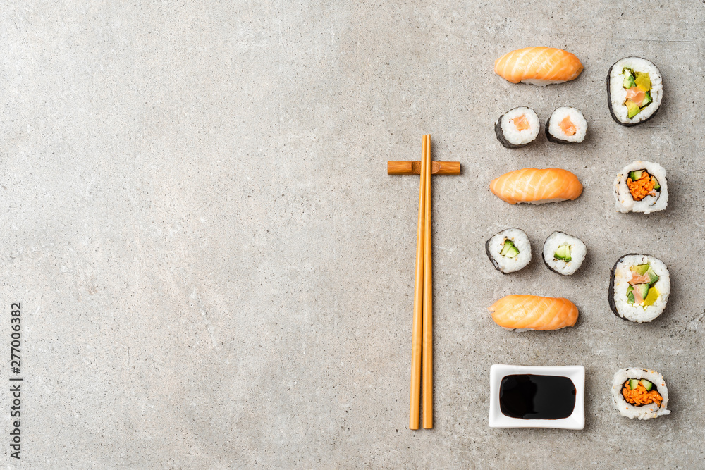 Various kinds of sushi on stone table with copysapce