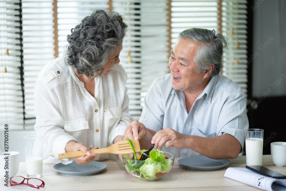 Happy Asian Senior couple doing salad.