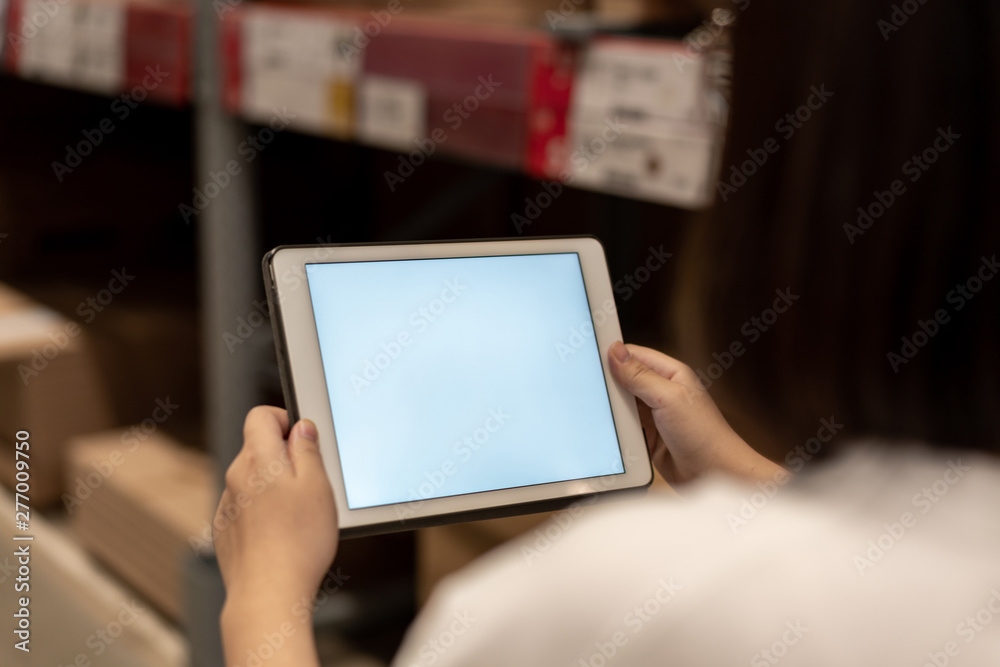 worker hand holding pad for check order pick time in smart factory warehouse