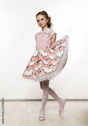 cute little girl in pink dress on white background. Children fashion, style concept.