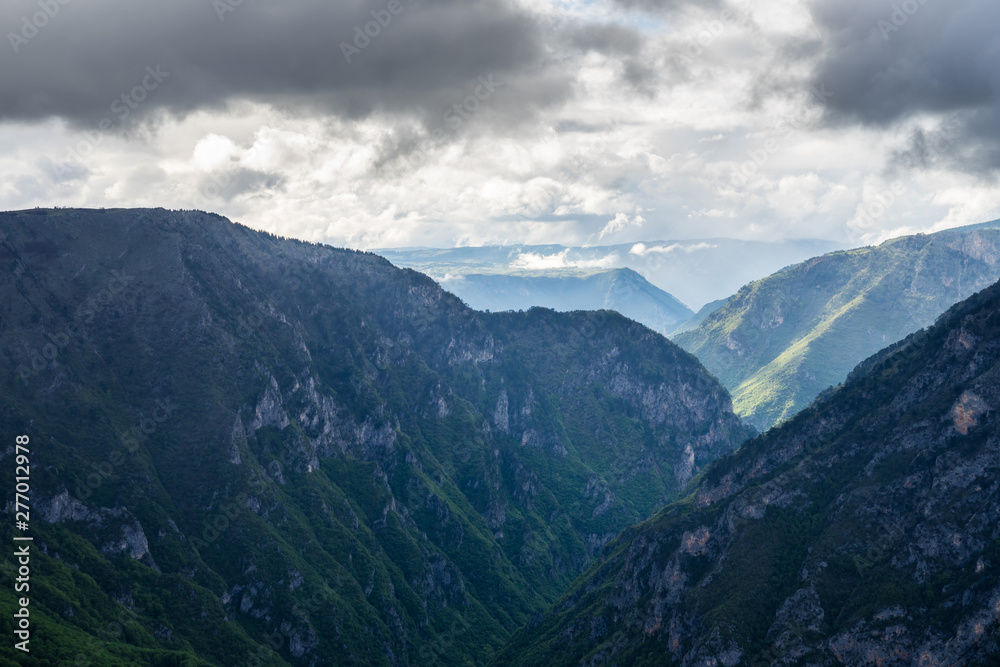 Montenegro, Beautiful dramatic sky over giant tara river canyon nature landscape from above in magical sunset light after heavy rain in durmitor national park near zabljak