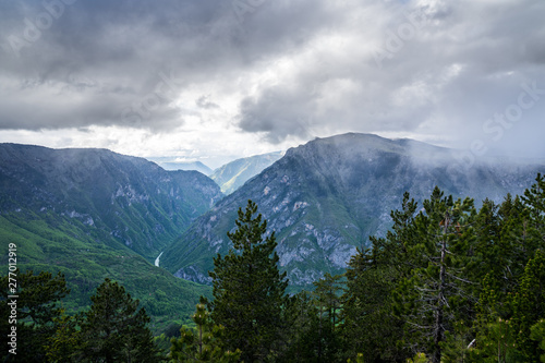 Montenegro, Spectacular view over tara river canyon with dramatic sky of rain clouds and sun from mountain curevac in durmitor national park nature landscape of zabljak
