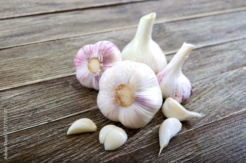 Garlic cloves, garlic bulb on wooden background. Fresh garlic close up. Concept of healthy food.