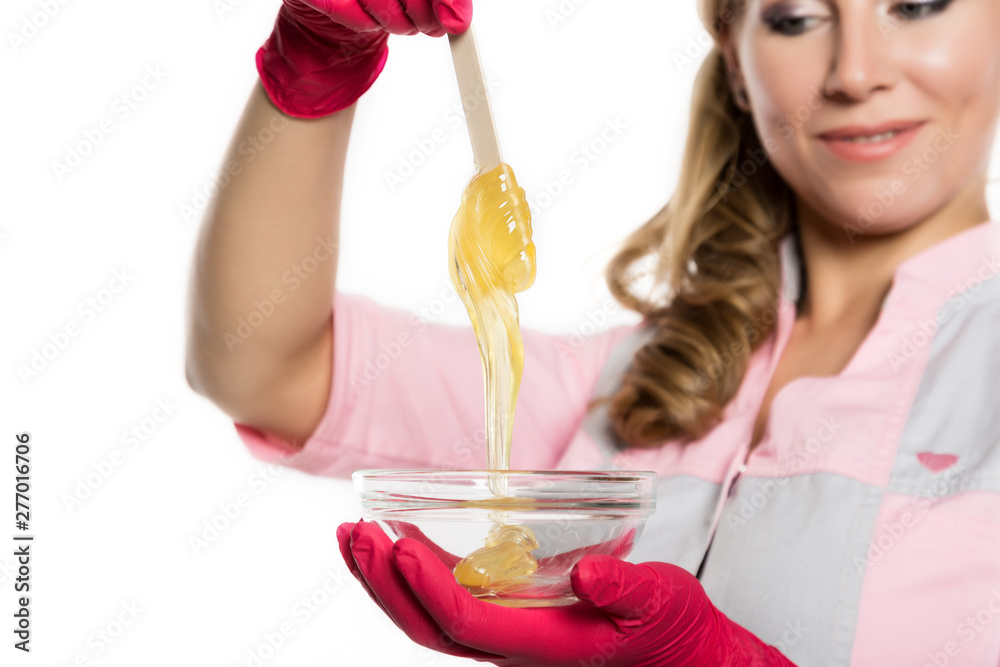 shugaring master in red gloves holds Wand with shugaring wax. depilation and beauty concept shugaring master in red gloves holds Wand with shugaring wax. depilation and beauty concept