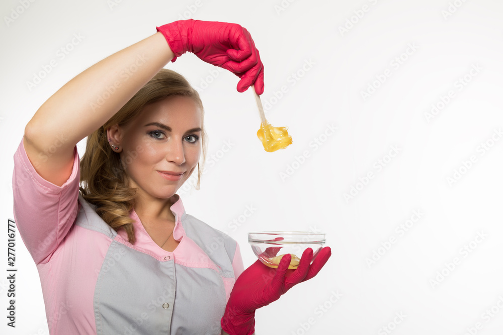 shugaring master in red gloves holds Wand with shugaring wax. depilation and beauty concept shugaring master in red gloves holds Wand with shugaring wax. depilation and beauty concept