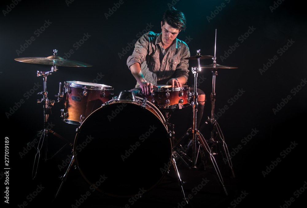 musician playing drums, black background and beautiful soft light musician playing drums, black background and beautiful soft light