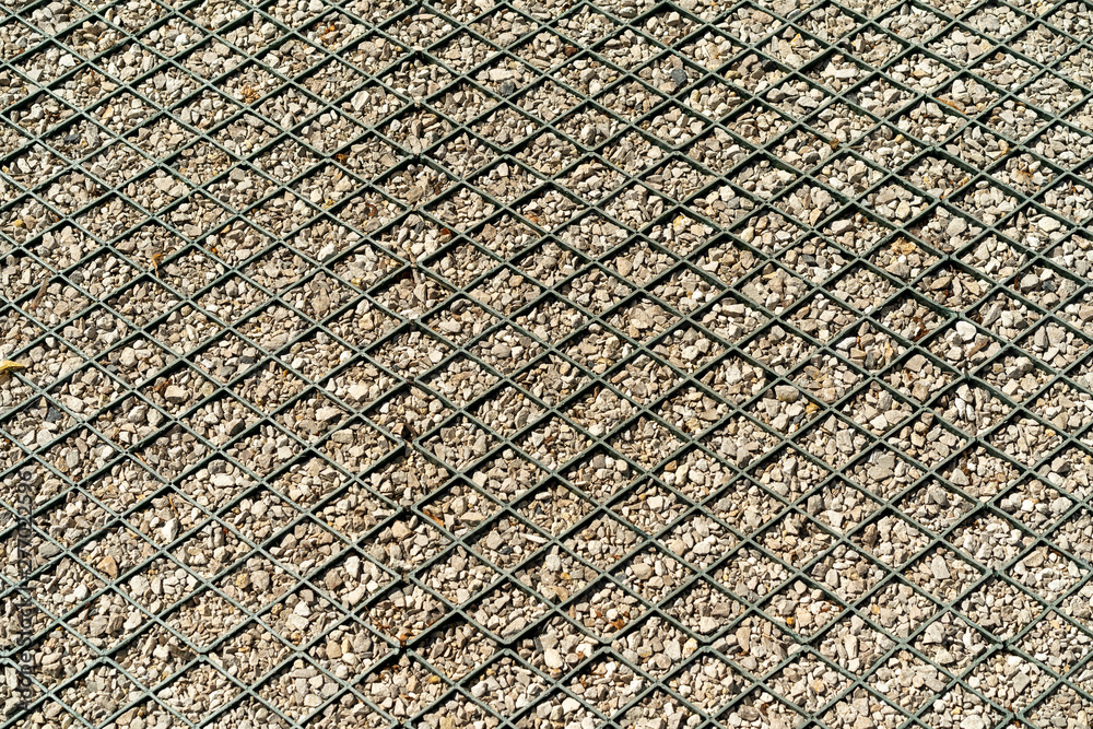 special pavement of metal mesh and small gravel for arranging parking space. Diamond-shaped structure with crushed stone. special pavement of metal mesh and small gravel for arranging parking space. Diamond-shaped structure with crushed stone.
