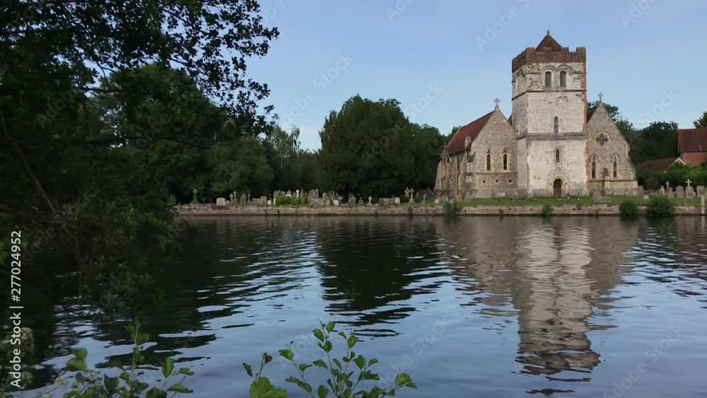 Typical English church by the river in England Typical English church by the river in England