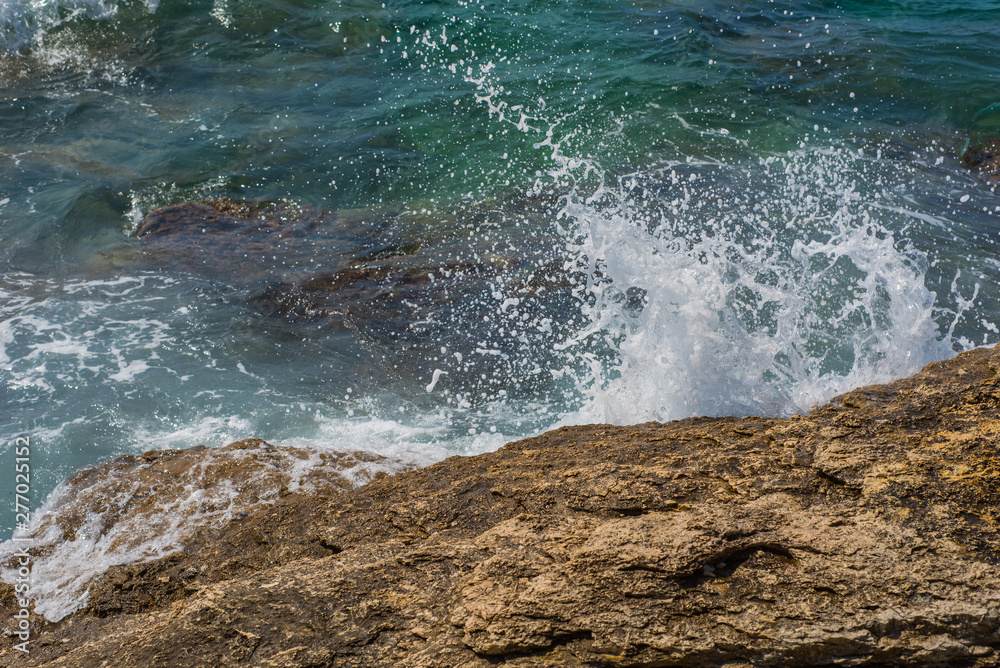 Waves breaking on a stony beach in Murter, Croatia, Dalmatia