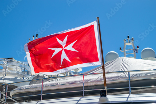 фотографія Maltese old flag on pole on ferry's stern