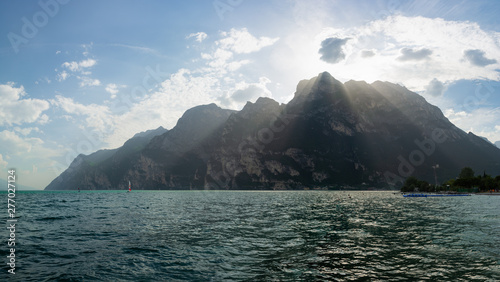 Beautiful view of crepuscular rays over the mountains around Riva Del Garda, Italy