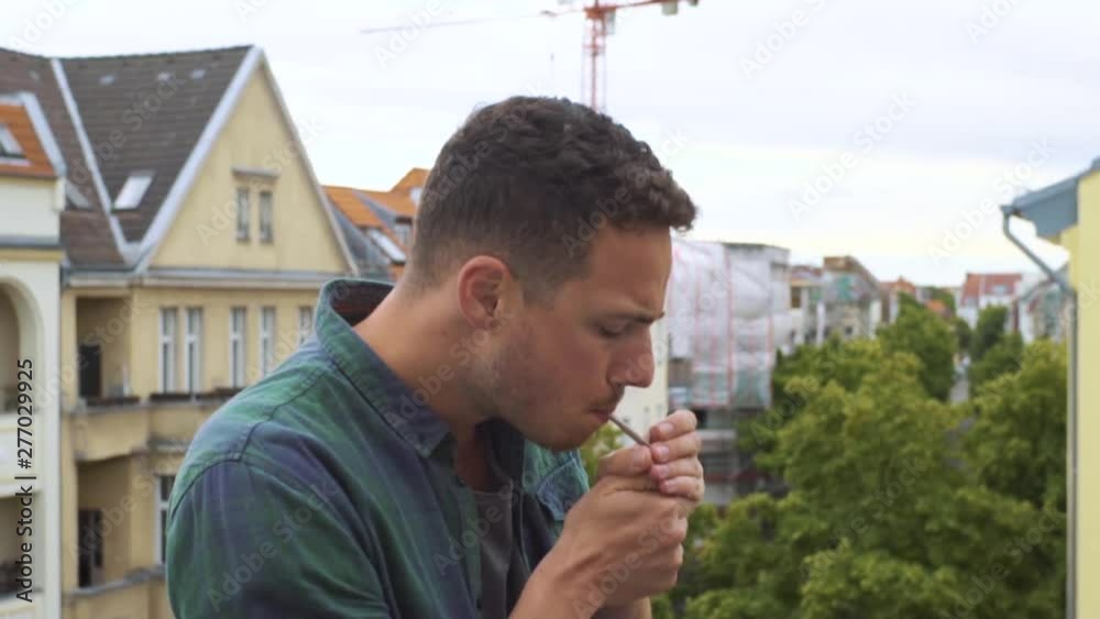 Guy smoking a cigarette on the stairs