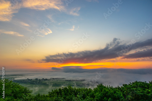 Dawn on a misty morning on a mountain above the river