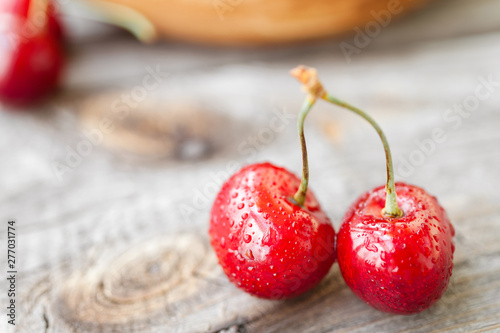 Fresh cherries on wooden background. Red ripe cherry. Food background