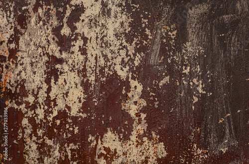 Old shabby rusty metal wall. Shabby, cracked brown paint. Grunge background