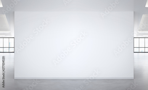 Fototapeta Naklejka Na Ścianę i Meble -  Blank wall in bright office mockup with large windows and sun passing through 3D rendering