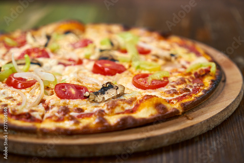 Delicious pizza with vegetables on the table
