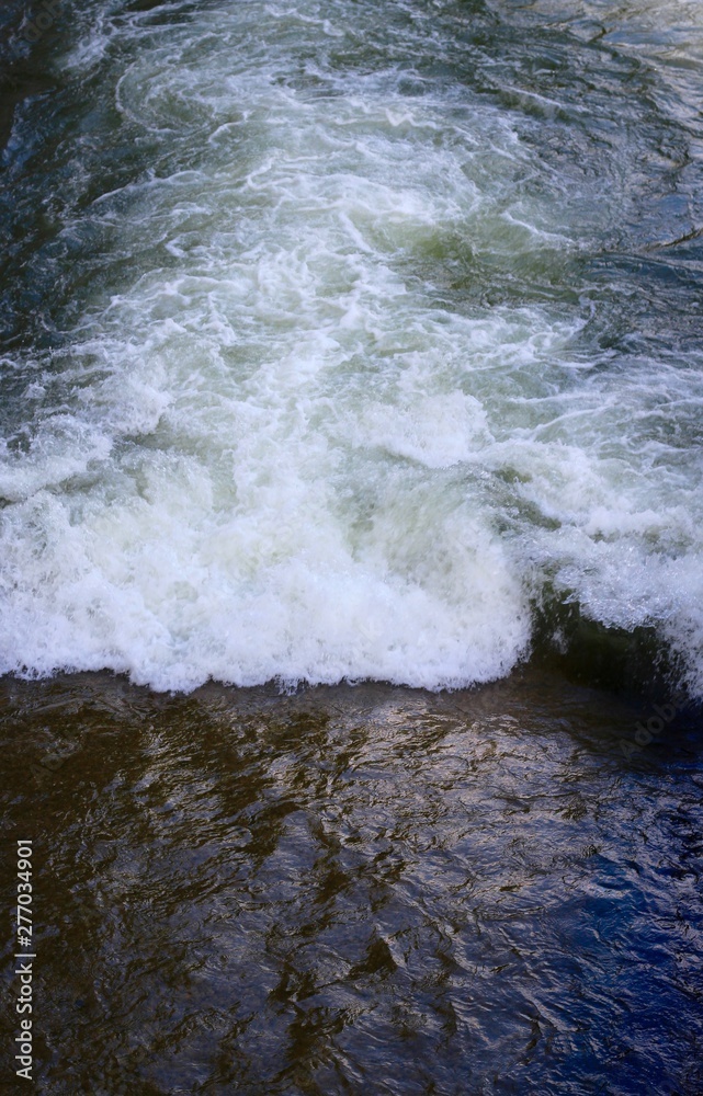 The waves and rapids in the water surface on a close view. The waves and rapids in the water surface on a close view.