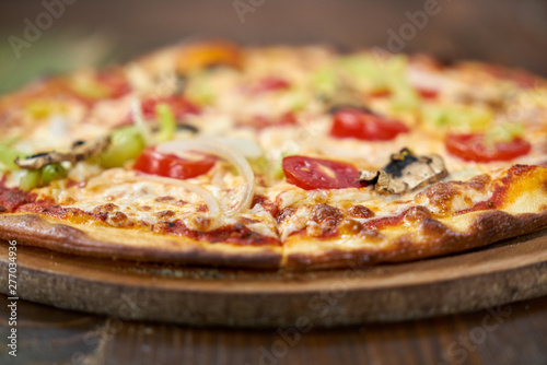 Delicious pizza with vegetables on the table