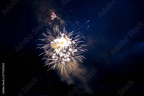 Bright fireworks in the night sky. Colorful firework display. Holiday celebration background