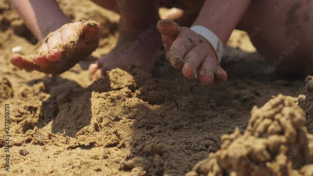 Girl playing on the beach building sand castle. Slow motion. Girl playing on the beach building sand castle. Slow motion.