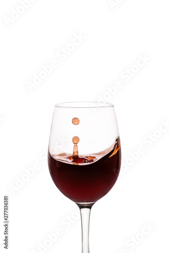 splash of red wine in glass isolated on white background.