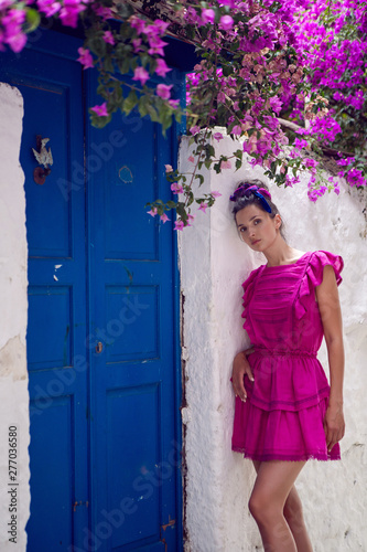 young beautiful woman in pink dress standing © saulich84