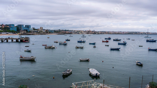 Cascais  Portugal docks and fishing boats  taken on a cloudy summer day  with beaches and buildings in the background