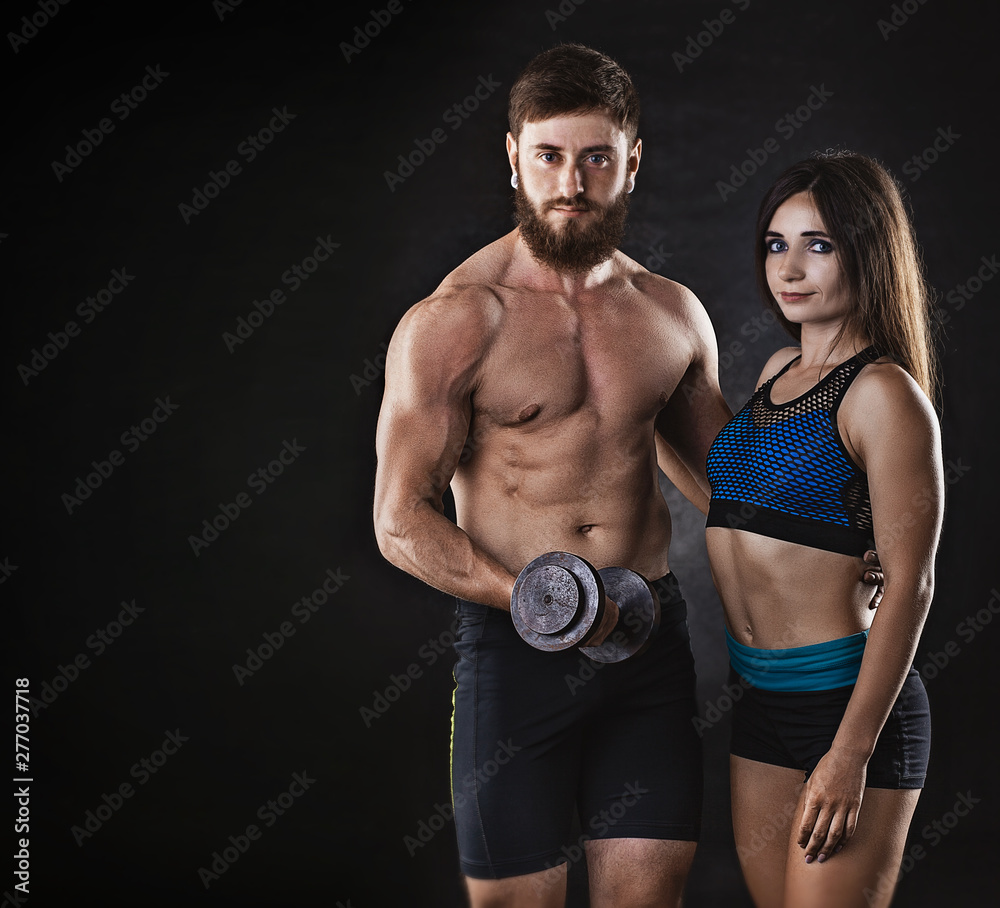 woman and man athletes on a black background. studio portrait woman and man athletes on a black background. studio portrait