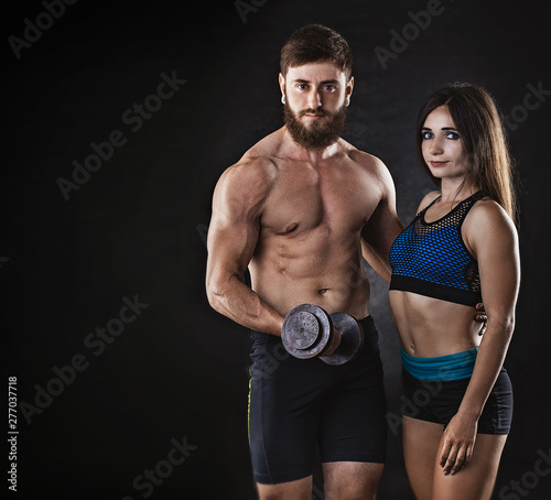 woman and man athletes on a black background. studio portrait