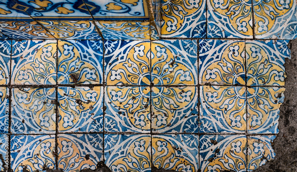 Old, hand painted traditional Portuguese tiles in yellow, blue & white. taken in Cascais.