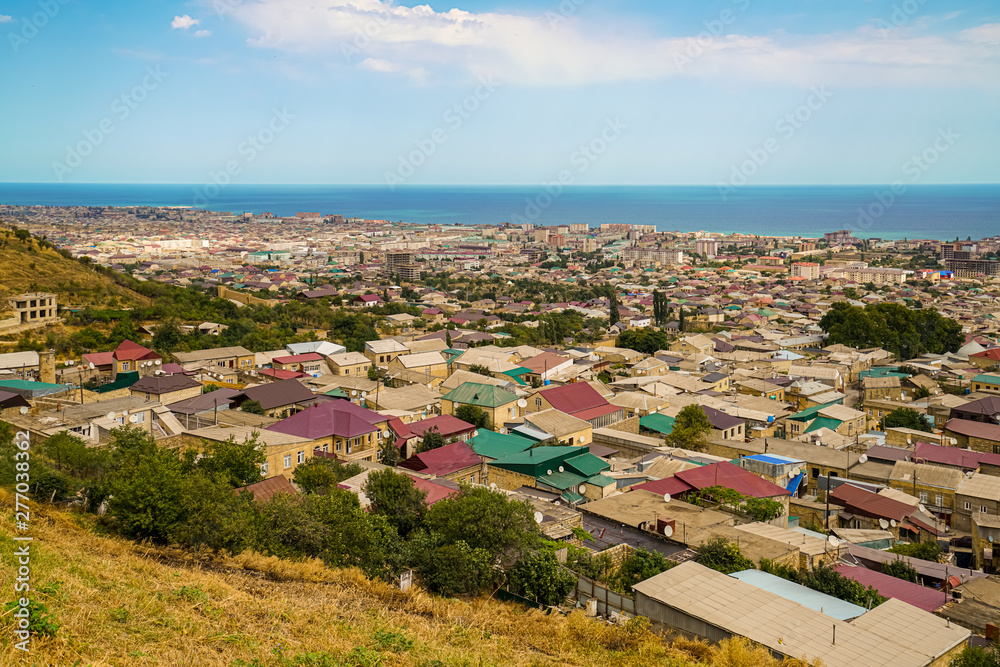 View of the city of Derbent and the Caspian Sea from the observation deck at the Naryn-Kala fortress. The roofs of the houses are dotted with satellite dishes.