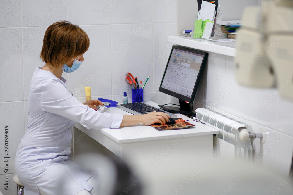 doctor sits at workplace, scientist woman works at the computer doctor sits at workplace, scientist woman works at the computer