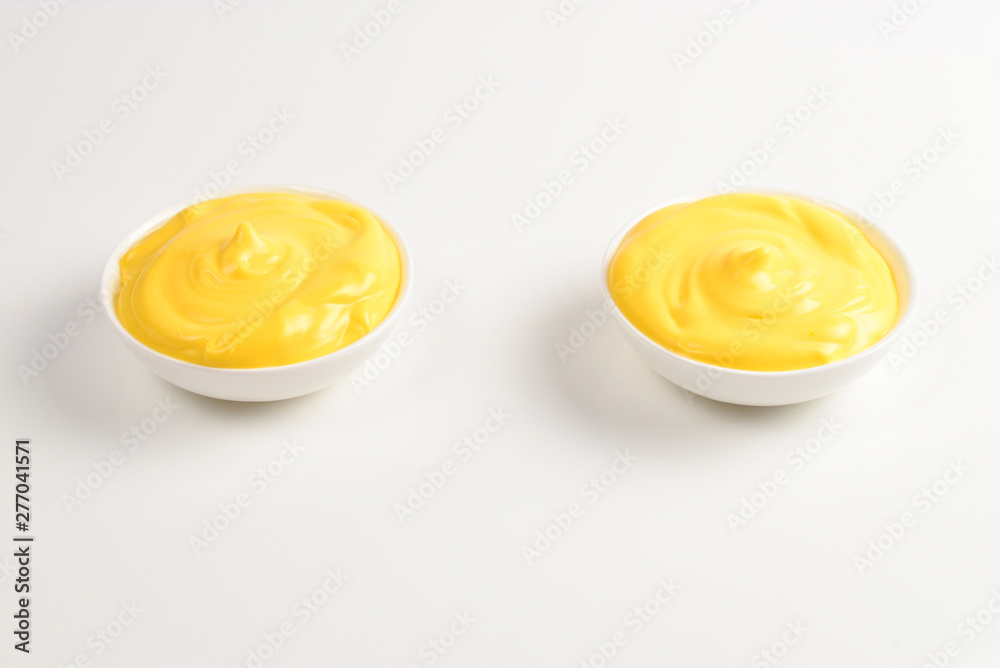 Cheese sauce in white plate on white background. Cheese sauce in white plate on white background.