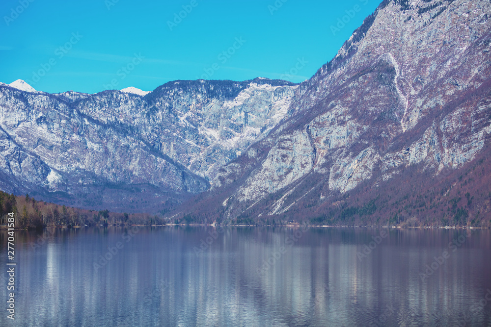 Mountain lake with reflection. Beautiful nature of Bohinj Lake (Bohinjsko jezero), Slovenia, Europe Mountain lake with reflection. Beautiful nature of Bohinj Lake (Bohinjsko jezero), Slovenia, Europe