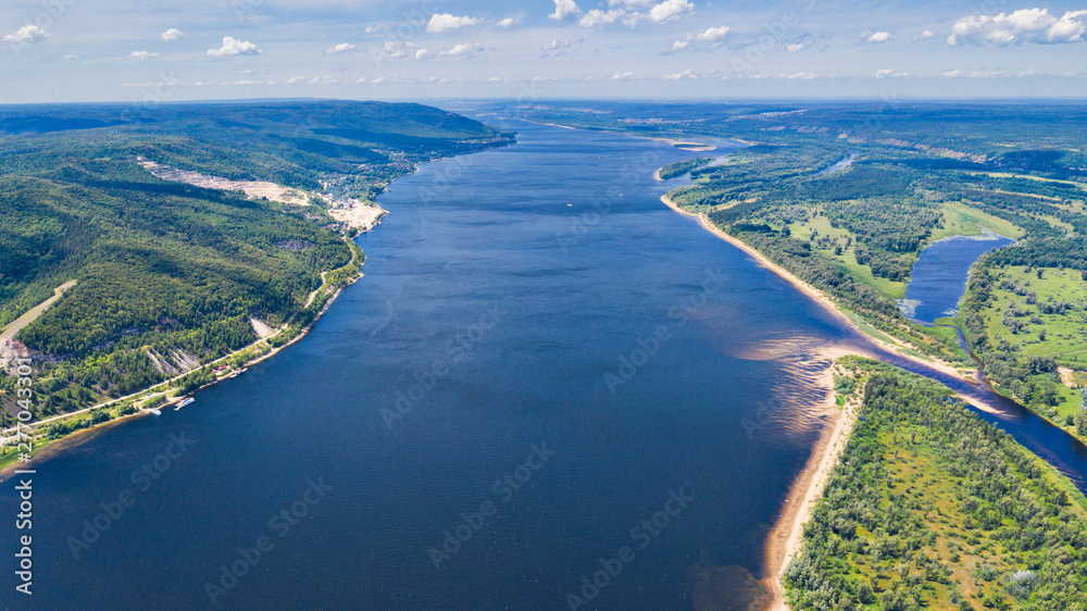 Naklejka premium Aerial view from the drone of landscape Volga river flows among the hills and fields. The middle band of Russia.