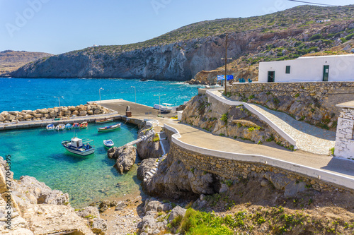 Fototapeta Naklejka Na Ścianę i Meble -  Potamos village with the port and the colorful fishing boats sailing in the turquoise sea waters in Antikythera island in Greece