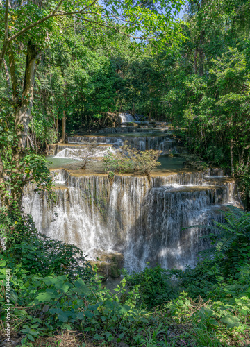 Many waterfalls flow in the frame of plants and green trees. Huai Mae Kamin Waterfall Viewpoint, Kanchanaburi Province