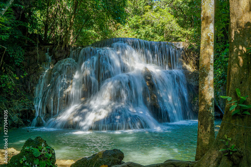 The clean waterfall there is an emerald green colour caused by reflections from trees and lichen circulating through the yellow limestone. Huai Mae Khamin Waterfall  Kanchanaburi Province