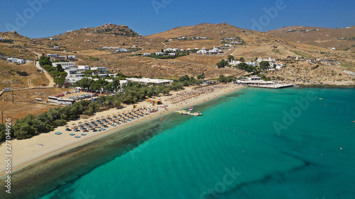 Aerial drone photo of famous organised with sun beds and umbrellas beach of Kalo Livadi with emerald clear sandy sea shore, Mykonos island, Cyclades, Greece 
