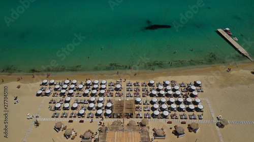 Aerial drone photo of famous organised with sun beds and umbrellas beach of Kalo Livadi with emerald clear sandy sea shore, Mykonos island, Cyclades, Greece 