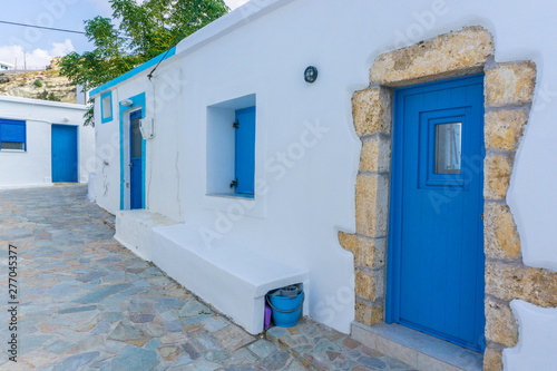 Street view of Potamos village with narrow alleys and traditional architecture in Antikythera island in Greece © Haris Andronos