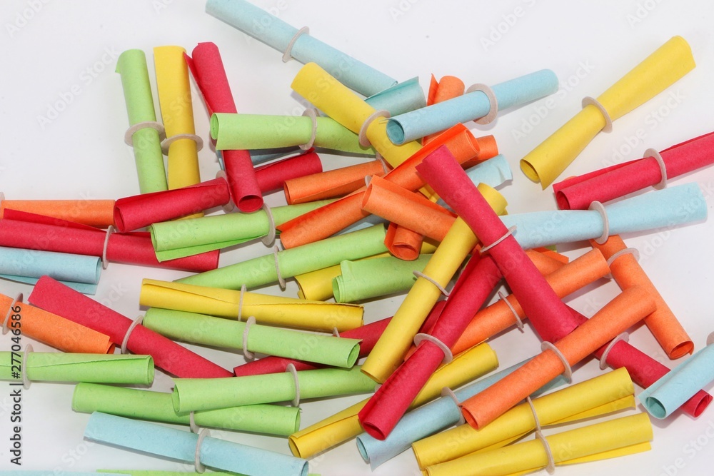 heap of colorful tombola tickets are lying in the white studio heap of colorful tombola tickets are lying in the white studio