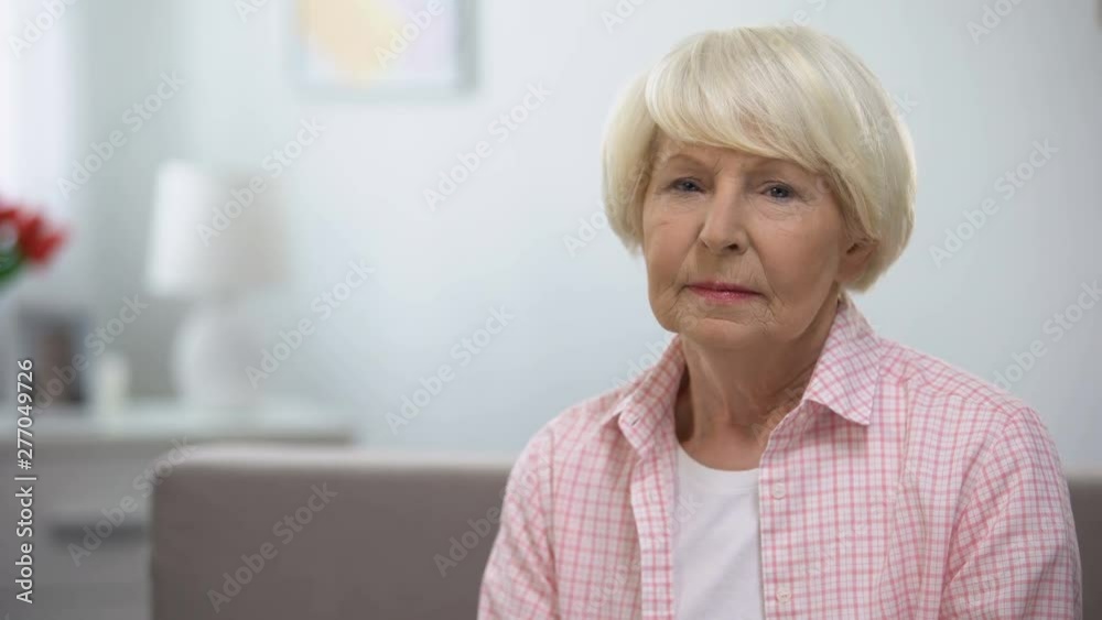 Depressed senior woman looking at camera, social insecurity, low incomes Depressed senior woman looking at camera, social insecurity, low incomes