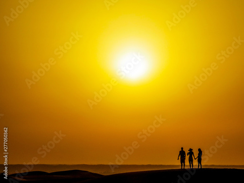 People Silhouette in the Desert at Sunset